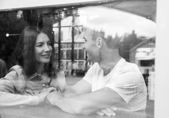 Young Couple Enjoying a Time Together at the Coffee Shop - Relax Time. Black & White Image - Selective Focus.
