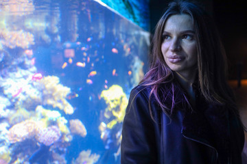 Portrait of girl look in aquarium 