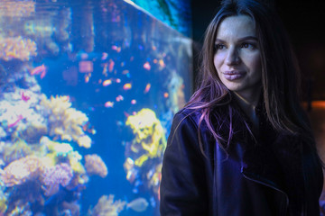 Portrait of girl look in aquarium 
