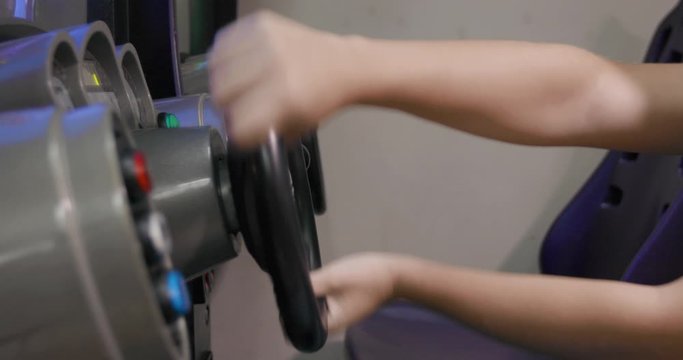 Teenage Playing Arcade Driving Game with Steering Wheel 