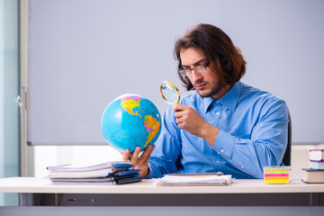 Young male teacher in the classroom