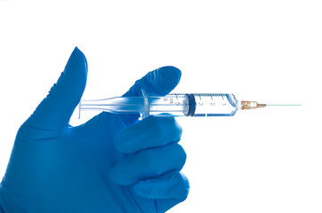 Hand wear blue rubber glove holding syringe of coronavirus (COVID-19) vaccine shot. 