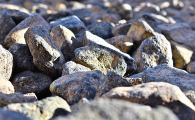 Closeup of blue gray rocks with rounded and rough, pointed edges paving a pathway