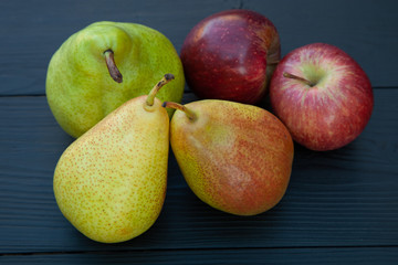 pears and apples on a dark wooden background