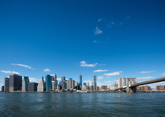 Fototapeta na wymiar Brooklyn Bridge and Manhattan skyline in New York with blue sky