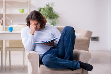 Young male student preparing for exams at home