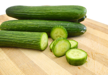 cucumber slices on wooden background
