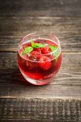 Raspberry and mint cocktail in glass on the rustic background. Selective focus. Shallow depth of field.