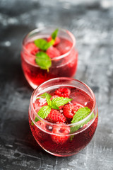 Raspberry and mint cocktail in glass on the rustic background. Selective focus. Shallow depth of field.