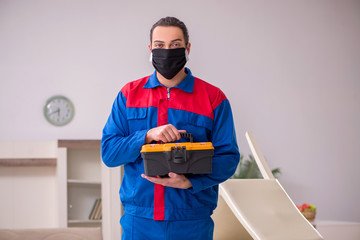 Young carpenter working indoors during pandemic disease
