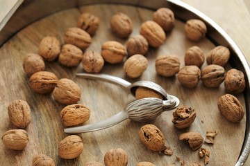 Nutcracker and Nuts.Walnuts close-up on wooden background. Tool for nuts. Delicious and healthy nuts.Keto diet 