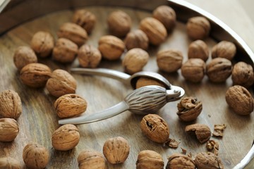 Nutcracker and Nuts.Walnuts close-up on wooden background. Tool for nuts. Delicious and healthy nuts.