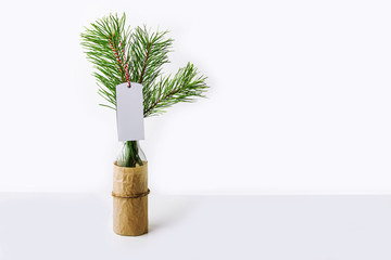 New year composition with Christmas tree branch in glass bottle and