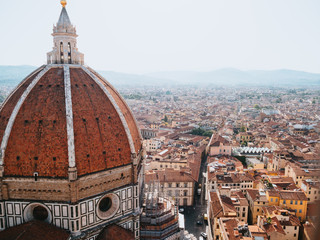 Fototapeta na wymiar Sunrise Panoramic View of Dome (Duomo) of Florence Cathedral (Cattedrale di Santa Maria del Fiore) from Giotto's Campanile (bell tower)