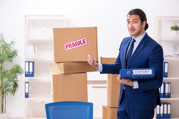 Young male logistics specialist working in the office