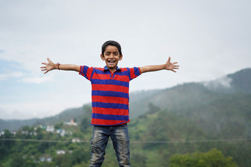 Portrait of a indian pahadi kid who belongs to the mountains. freedom and joy