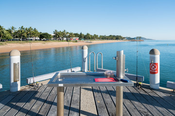 Popular fishing spot on the Strand jetty or pier with fish cleaning station in Townsville, North Queensland