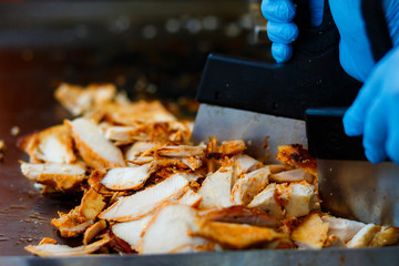 Close-up meat on special equipment, cook shawarma