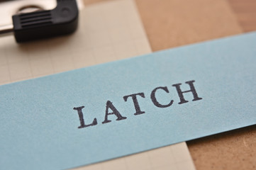  The initials of "Location, Alphabet, Time, Category, Hierarchy" as "LATCH" stamped on slip with clipboard. It is method of classification of information.