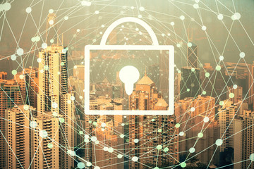 Lock icon hologram on city view with skyscrapers background multi exposure. Data security concept.