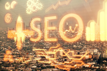 Fototapeta premium SEO hologram on city view with skyscrapers background double exposure. Search optimization concept.