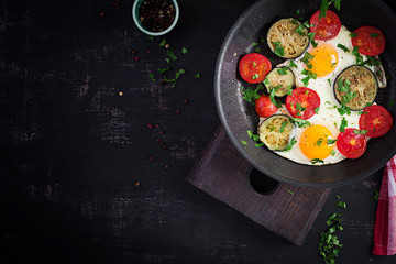 English breakfast - fried eggs, tomatoes and eggplant. American food. Top view, overhead, copy space