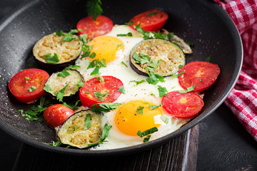 English breakfast - fried eggs, tomatoes and eggplant. American food.