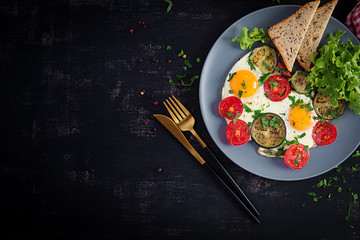 English breakfast - fried eggs, tomatoes and eggplant. American food. Top view, overhead, copy space
