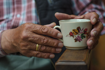 man holding cup of coffee