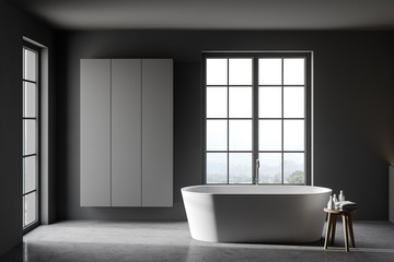 Obraz na płótnie Canvas Grey bathroom with tub and cabinet