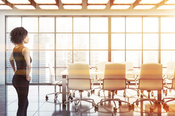 African woman in white meeting room