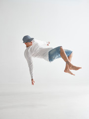 Cool stylish guy dancer levitating isolated on white background. Dance school poster. Photography...