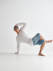 Cool guy breakdancer dancing lower break dance isolated on white background. Dance school poster. Break dance lessons