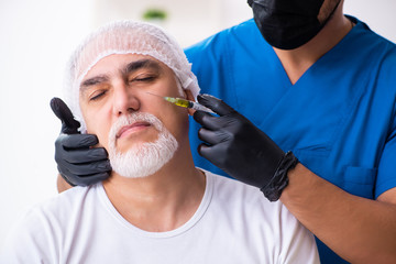 Old man visiting male doctor for plastic surgery