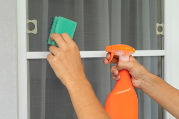 Washing from dust mosquito net. Cleaning mosquito wire screen.