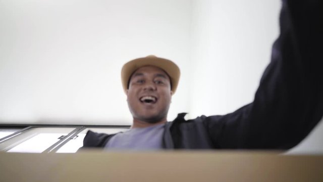 
Fast post shipment service concept. Smiling young man customer opening parcel cardboard.  Happy consumer unpacking postal shipping delivery satisfied with good purchase. 4k Resolution.