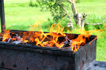 fire burning in the grill on a picnic