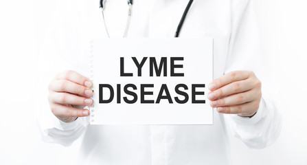 LYME DISEASE Lyme disease or Lyme borreliosis. Text on the card in the hands of the doctor