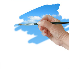 Hand painting blue sky with paintbrush