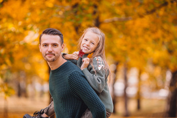 Fototapeta premium Family of dad and kid on beautiful autumn day in the park