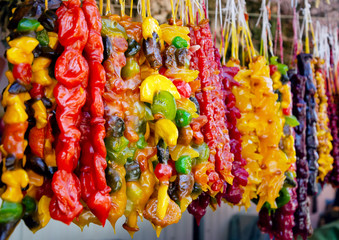 Churchkhela on the market. Traditional Caucasian homemade sweets with hazelnuts, walnuts, grape juice, honey, wheat flour.