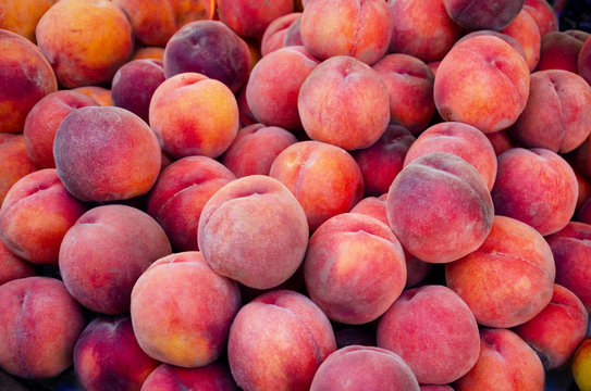 Fresh peaches in farmers market. Natural background for your design.