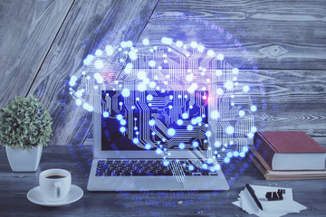 Double exposure of work space with computer and human brain drawing hologram. Brainstorm concept.