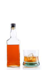 Bottle of whisky and glass of whisky with ice isolated on white background with copy space.