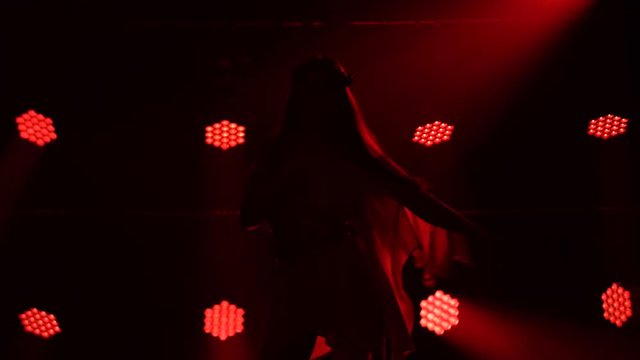 Enchanting girl in greek greece goddes dress and wreath high fashion demonstrating the flexibility and sexuality of the body in dance. Silhouette.