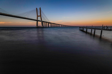 Naklejka na ściany i meble The Vasco da Gama Bridge is a cable-stayed bridge flanked by viaducts and spans the Tagus River in Parque das Nações in Lisbon, the capital of Portugal. It is the longest bridge in the European Union