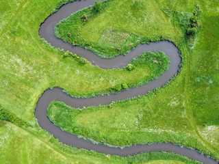 Aerial view landscape of winding river in green field.