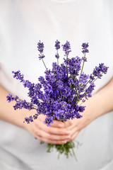 Woman hands holding lavender flowers bouquet