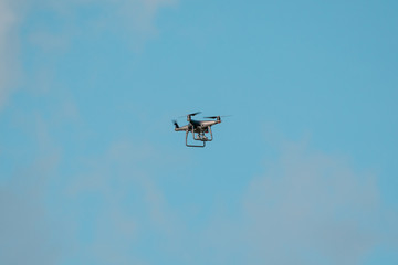 Drone quadcopter flying in a sky
