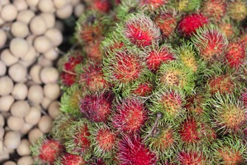 Closeup of some exotic fruits at a Thai market: Longan and Rambutan! Fresh and delicious!